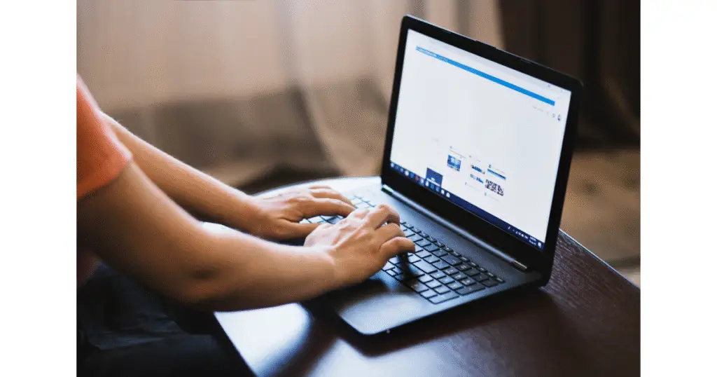 Content creator using subtitle time shifter tool on their laptop